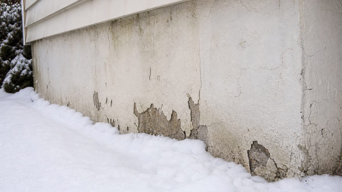 雪が寄せられた住宅の外壁の下部
